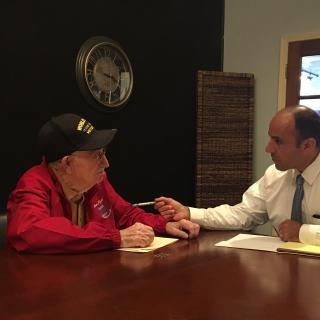 Military soldier saluting American flag