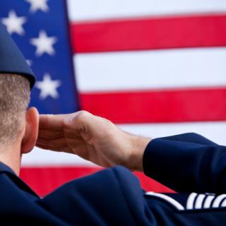 soldier saluting the US flag